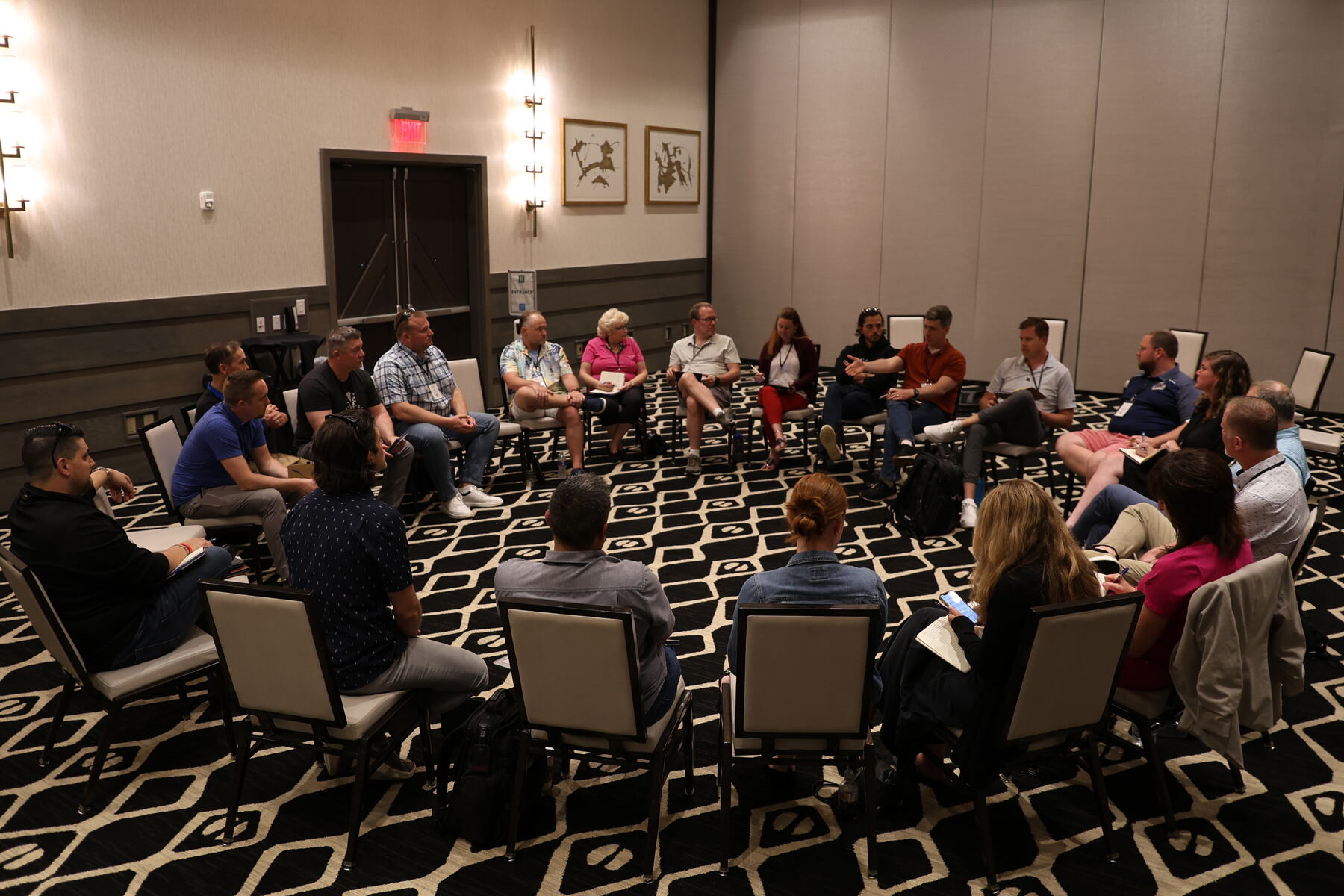 Agency owners seated in a wide circle for a hot seat session at a past retreat
