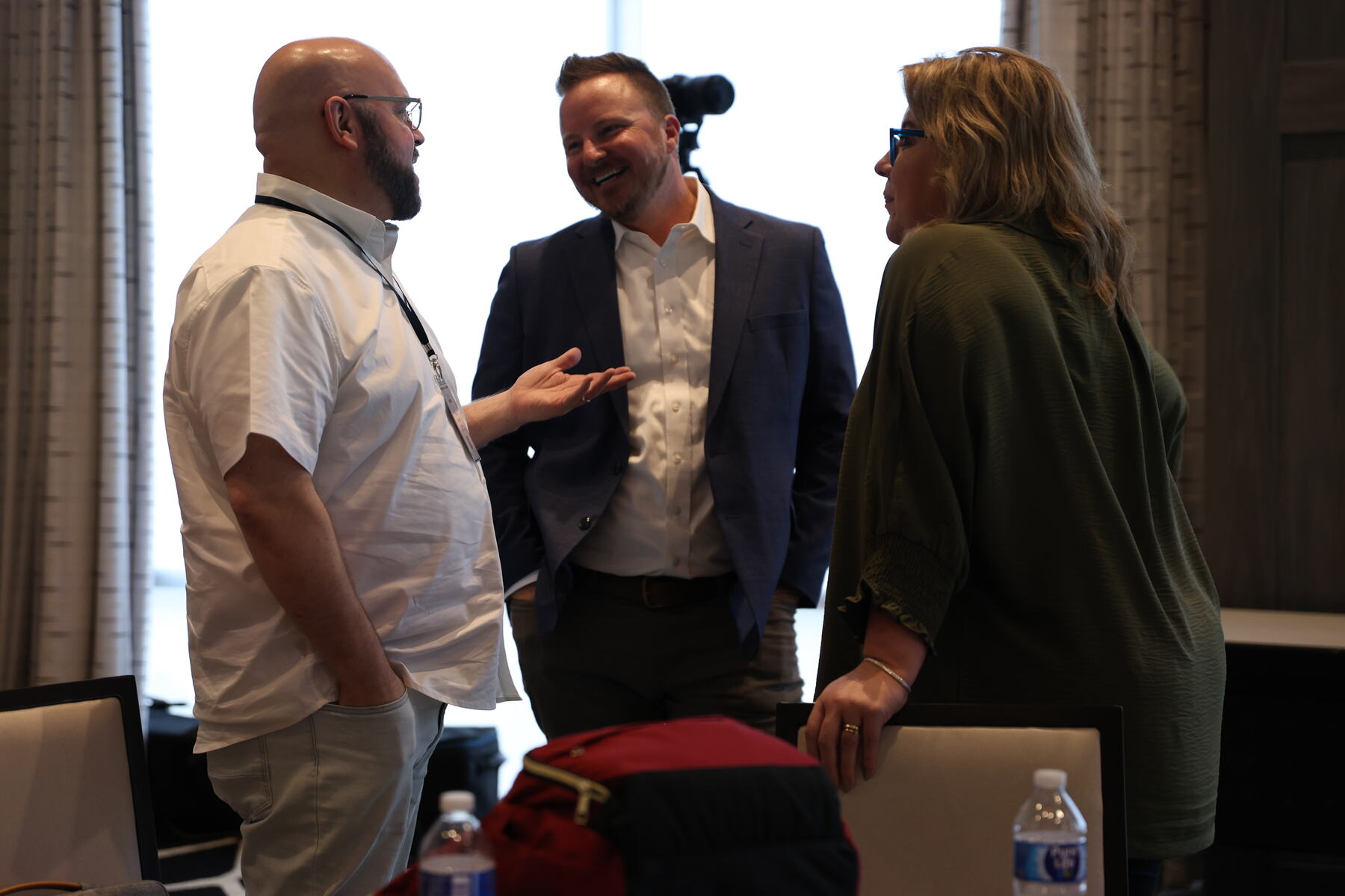 Three attendees talking between sessions