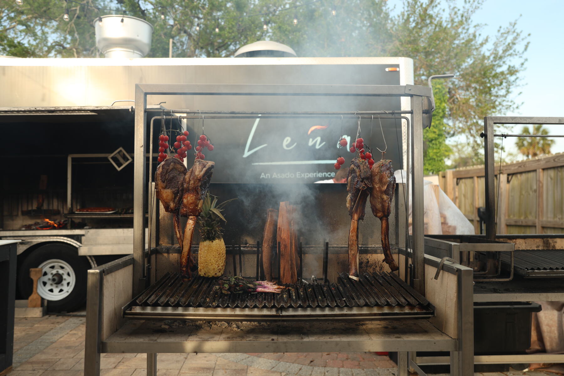 Meat and peppers roasting over an open fire grill at the retreat dinner